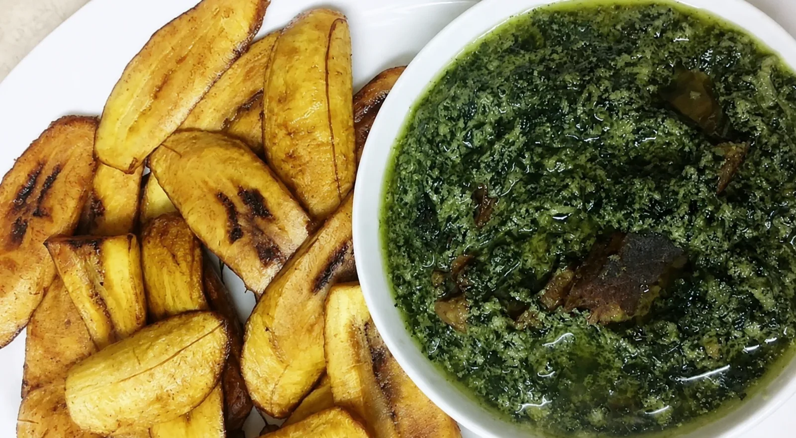 Ndole served with fried plantains